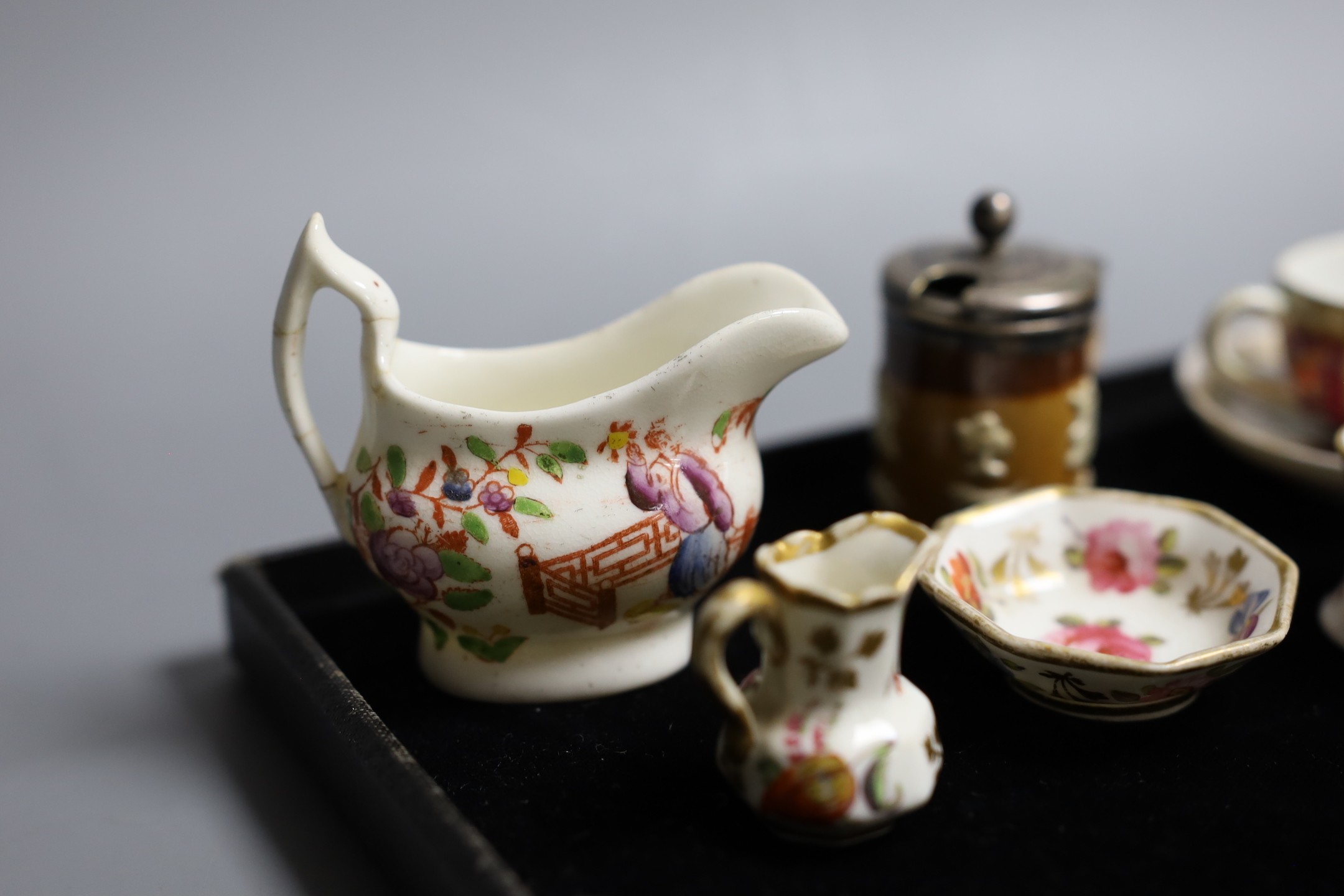 Miniatures: A Spode type Hydra jug and basin painted with flowers, a Crown Staffordshire two handled mug with flowers on a gilded blue ground, two continental cups and saucer one with Watteauesque scenes, the other in bl